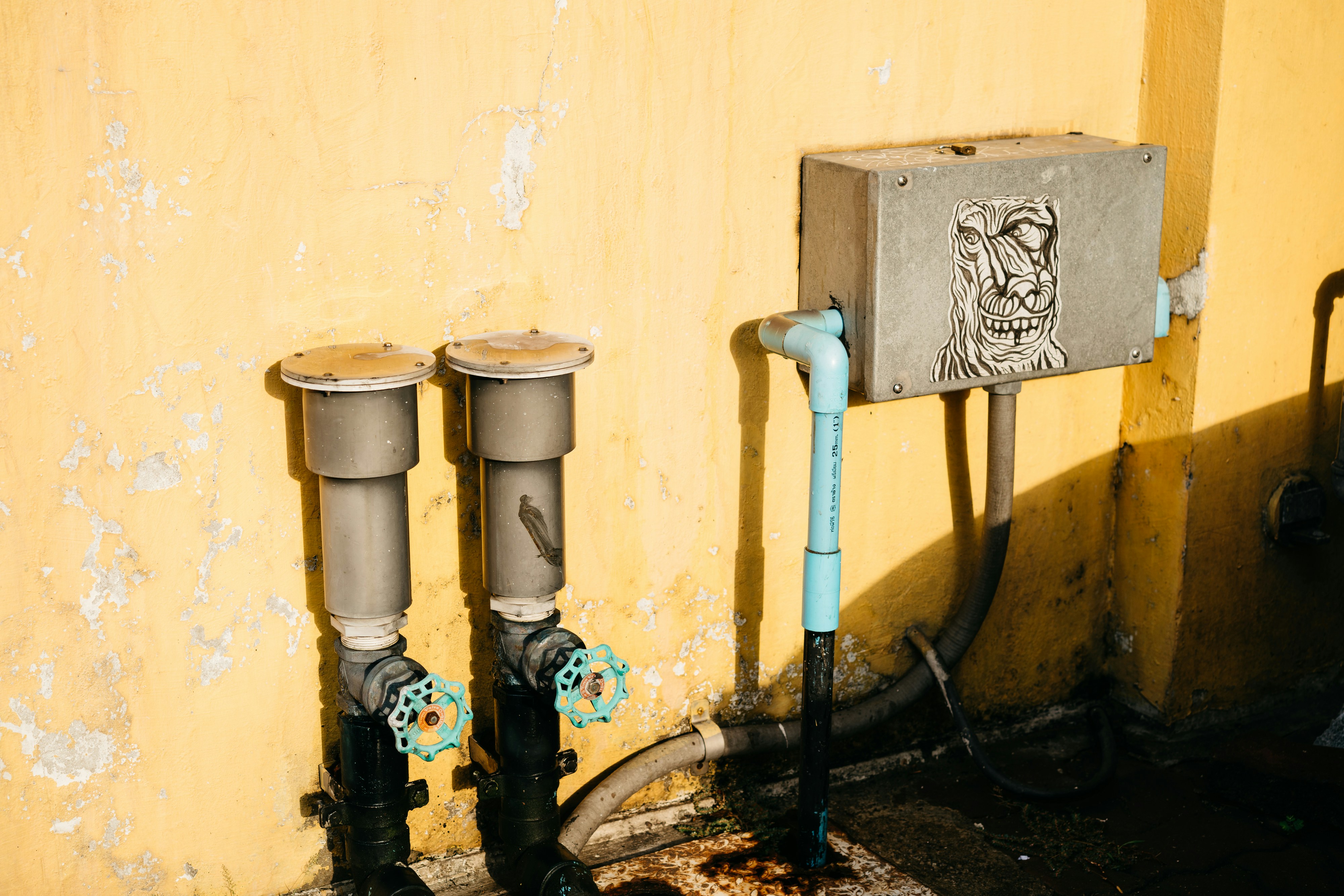 Wall-mounted pipe valves and water meter connections